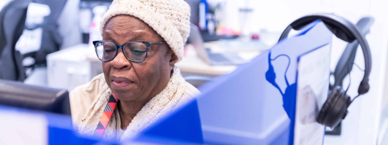 A woman sits at a computer